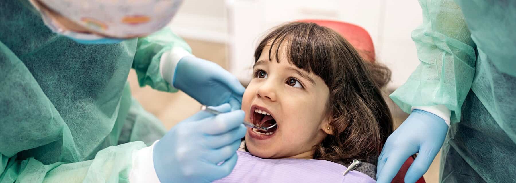 A dentist carefully examines a child's teeth, Spokane Valley Washington