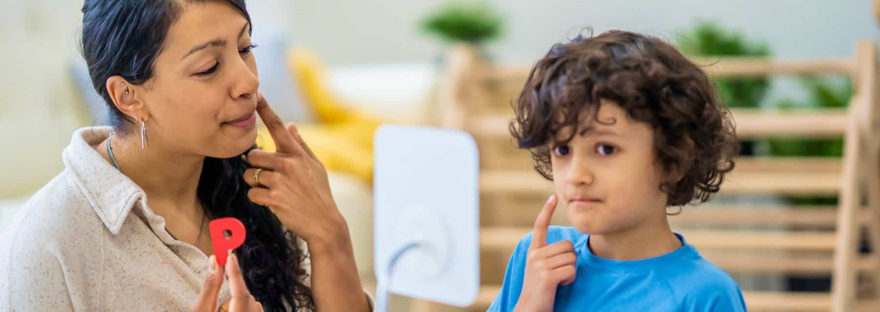 A woman and a child engage in myofunctional therapy at Spokane Valley Washington