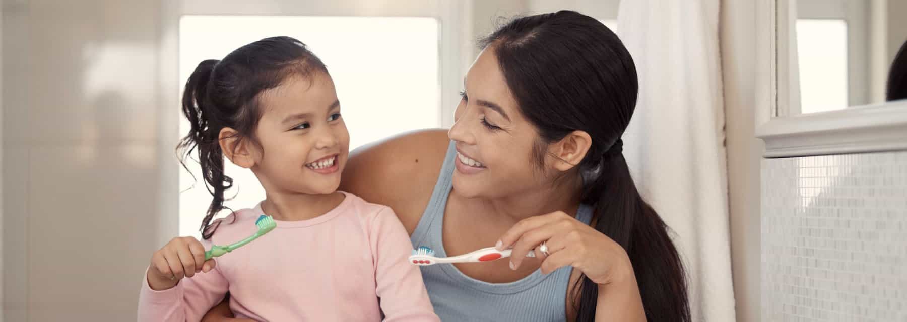 A woman and a child are brushing their teeth together, Spokane Valley Washington