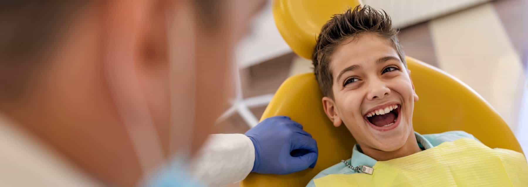A smiling boy relaxes in the dentist chair in Spokane Valley Washington
