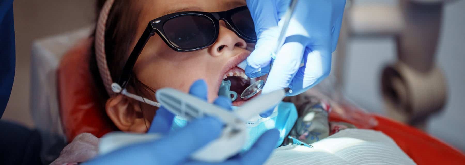 A child receiving a dental checkup in a modern dentist's chair, Washington